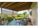 Charming covered patio with a patterned rug and view of the well-manicured lawn at 5410 Brassie Dr, Indianapolis, IN 46235