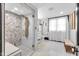 Luxurious bathroom featuring a modern shower with pebble flooring and elegant marble countertops at 543 Fletcher Ave, Indianapolis, IN 46203