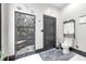 Modern bathroom featuring a glass-enclosed shower and sleek tile flooring at 543 Fletcher Ave, Indianapolis, IN 46203