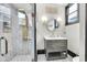 Bathroom featuring gold fixtures, glass shower and patterned stone floor at 543 Fletcher Ave, Indianapolis, IN 46203