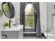 Bathroom offers a glass sink, gray cabinets, and a window offering an outdoor view at 543 Fletcher Ave, Indianapolis, IN 46203