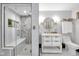 Bright bathroom with a stylish vanity, round mirror, modern fixtures, and spacious walk-in shower at 543 Fletcher Ave, Indianapolis, IN 46203