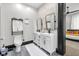 Modern bathroom with double vanity, exposed brick, and dark trim leading to the bedroom at 543 Fletcher Ave, Indianapolis, IN 46203