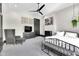 Comfortable bedroom boasts neutral decor, stylish furnishings, and a ceiling fan at 543 Fletcher Ave, Indianapolis, IN 46203