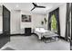 Cozy bedroom with gray trim, modern ceiling fan, a large window, and a stylish decor at 543 Fletcher Ave, Indianapolis, IN 46203