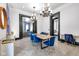 Spacious dining room leads to the living room with stylish blue chairs and modern lighting at 543 Fletcher Ave, Indianapolis, IN 46203