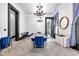Bright dining room featuring stylish blue chairs, modern lighting, and elegant decor at 543 Fletcher Ave, Indianapolis, IN 46203