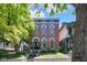 Charming brick home with arched windows and a blue accent trim under a beautiful, sunny sky at 543 Fletcher Ave, Indianapolis, IN 46203