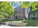 Charming brick home with arched windows and a blue accent trim, framed by a lush green tree at 543 Fletcher Ave, Indianapolis, IN 46203