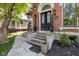 Elegant front entry with landscaped steps leading to a black double door with decorative glass at 543 Fletcher Ave, Indianapolis, IN 46203