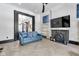 Stylish living room features a decorative fireplace, hardwood floors, and comfortable blue sofa at 543 Fletcher Ave, Indianapolis, IN 46203