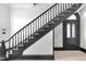 Elegant staircase with dark wood railings and light wood floors, leading to a landing at 543 Fletcher Ave, Indianapolis, IN 46203
