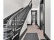 Elegant staircase with dark wood railings and light wood floors, with view of hall at 543 Fletcher Ave, Indianapolis, IN 46203