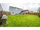 Backyard with patio, pergola and dining area, offers a great space for outdoor activities at 5522 Grassy Bank Dr, Indianapolis, IN 46237