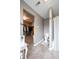 A well-lit bathroom with an open walk-in closet featuring modern fixtures and neutral gray walls at 5522 Grassy Bank Dr, Indianapolis, IN 46237