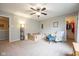 Cozy bedroom featuring a ceiling fan, a colorful armchair, and an open closet at 5522 Grassy Bank Dr, Indianapolis, IN 46237