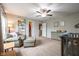 Bright bedroom featuring a ceiling fan, comfortable chair and footrest, and a baby crib at 5522 Grassy Bank Dr, Indianapolis, IN 46237