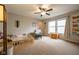 Bright bedroom featuring a ceiling fan, two windows, and comfortable furnishings at 5522 Grassy Bank Dr, Indianapolis, IN 46237