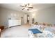 Bright bedroom with a white dresser and a comfortable chair at 5522 Grassy Bank Dr, Indianapolis, IN 46237