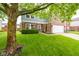 Two-story home with brick and siding, features a two car garage and manicured lawn at 5522 Grassy Bank Dr, Indianapolis, IN 46237