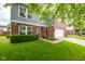 Two-story home with brick and siding, features a two car garage and manicured lawn at 5522 Grassy Bank Dr, Indianapolis, IN 46237