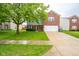 Two-story home with brick and siding, features a two car garage and manicured lawn at 5522 Grassy Bank Dr, Indianapolis, IN 46237