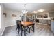 Bright kitchen featuring gray cabinets, stainless steel appliances, and an adjoining dining area at 5522 Grassy Bank Dr, Indianapolis, IN 46237