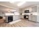 Open-concept kitchen with gray cabinets, modern appliances, and a view into the living area at 5522 Grassy Bank Dr, Indianapolis, IN 46237