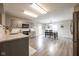 Modern kitchen with gray cabinets, stainless steel appliances, and an adjacent dining area at 5522 Grassy Bank Dr, Indianapolis, IN 46237