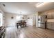 Modern kitchen with gray cabinets, stainless steel appliances, and an adjacent dining area at 5522 Grassy Bank Dr, Indianapolis, IN 46237