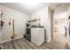 Functional laundry room with shelving for storage, gray floors, and modern appliances at 5522 Grassy Bank Dr, Indianapolis, IN 46237