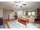 Open living room featuring a neutral sofa, area rug, and hardwood floors at 5522 Grassy Bank Dr, Indianapolis, IN 46237