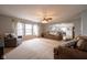 Bright living room featuring neutral carpet, two couches, and a large window at 5522 Grassy Bank Dr, Indianapolis, IN 46237