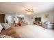 Open living room with comfortable seating, a ceiling fan, and an open view to the kitchen and entry at 5522 Grassy Bank Dr, Indianapolis, IN 46237