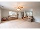 Bright living room featuring neutral carpet, two couches, and a large window at 5522 Grassy Bank Dr, Indianapolis, IN 46237