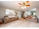 Bright living room featuring neutral carpet, two couches, and a large window at 5522 Grassy Bank Dr, Indianapolis, IN 46237