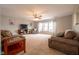 Spacious living room with neutral carpet, ceiling fan, and cozy seating arrangement at 5522 Grassy Bank Dr, Indianapolis, IN 46237