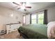 Spacious main bedroom with a ceiling fan, offering access to the ensuite and natural light at 5522 Grassy Bank Dr, Indianapolis, IN 46237