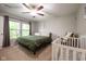 Well-lit main bedroom with a ceiling fan and large windows offering scenic views at 5522 Grassy Bank Dr, Indianapolis, IN 46237