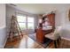 Comfortable office space with a large wooden desk, chair, and bright windows at 5522 Grassy Bank Dr, Indianapolis, IN 46237
