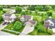 Aerial view of a charming home with a well-manicured lawn, two car garage, and green trimmed windows at 5523 Gainesway Dr, Greenwood, IN 46142