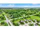 Serene neighborhood featuring tree-lined streets and beautifully maintained homes under a blue sky with fluffy clouds at 5523 Gainesway Dr, Greenwood, IN 46142
