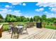 Enjoy outdoor living on this deck with a dining set and grill overlooking the lush backyard at 5523 Gainesway Dr, Greenwood, IN 46142