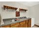 Finished basement bar area features custom glass racks and a beverage refrigerator for entertaining at 5523 Gainesway Dr, Greenwood, IN 46142
