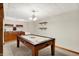 Finished basement with an air hockey table and bar area for relaxation and entertaining at 5523 Gainesway Dr, Greenwood, IN 46142