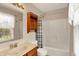 Well-lit bathroom featuring a combined shower and tub unit and a vanity with a sink at 5523 Gainesway Dr, Greenwood, IN 46142