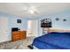 Cozy bedroom with light blue walls, ceiling fan, gray carpet and colorful New England Patriots decor at 5523 Gainesway Dr, Greenwood, IN 46142