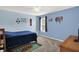 A bright bedroom decorated with sports theme and plush carpeting at 5523 Gainesway Dr, Greenwood, IN 46142