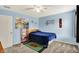 Sports themed bedroom featuring blue walls, posters, decor, a ceiling fan and plush carpet at 5523 Gainesway Dr, Greenwood, IN 46142