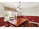 Traditional dining room featuring a wood table, six chairs, and natural light at 5523 Gainesway Dr, Greenwood, IN 46142
